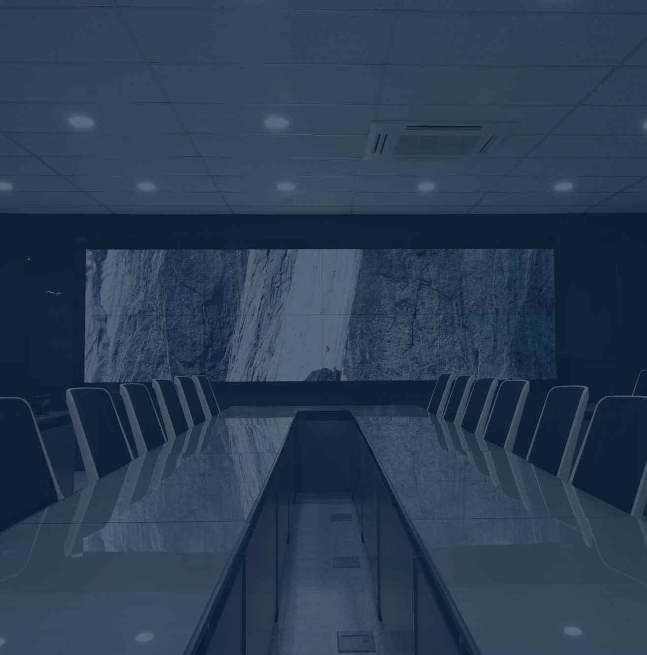 Corporate conference room with a large video wall display and long meeting table