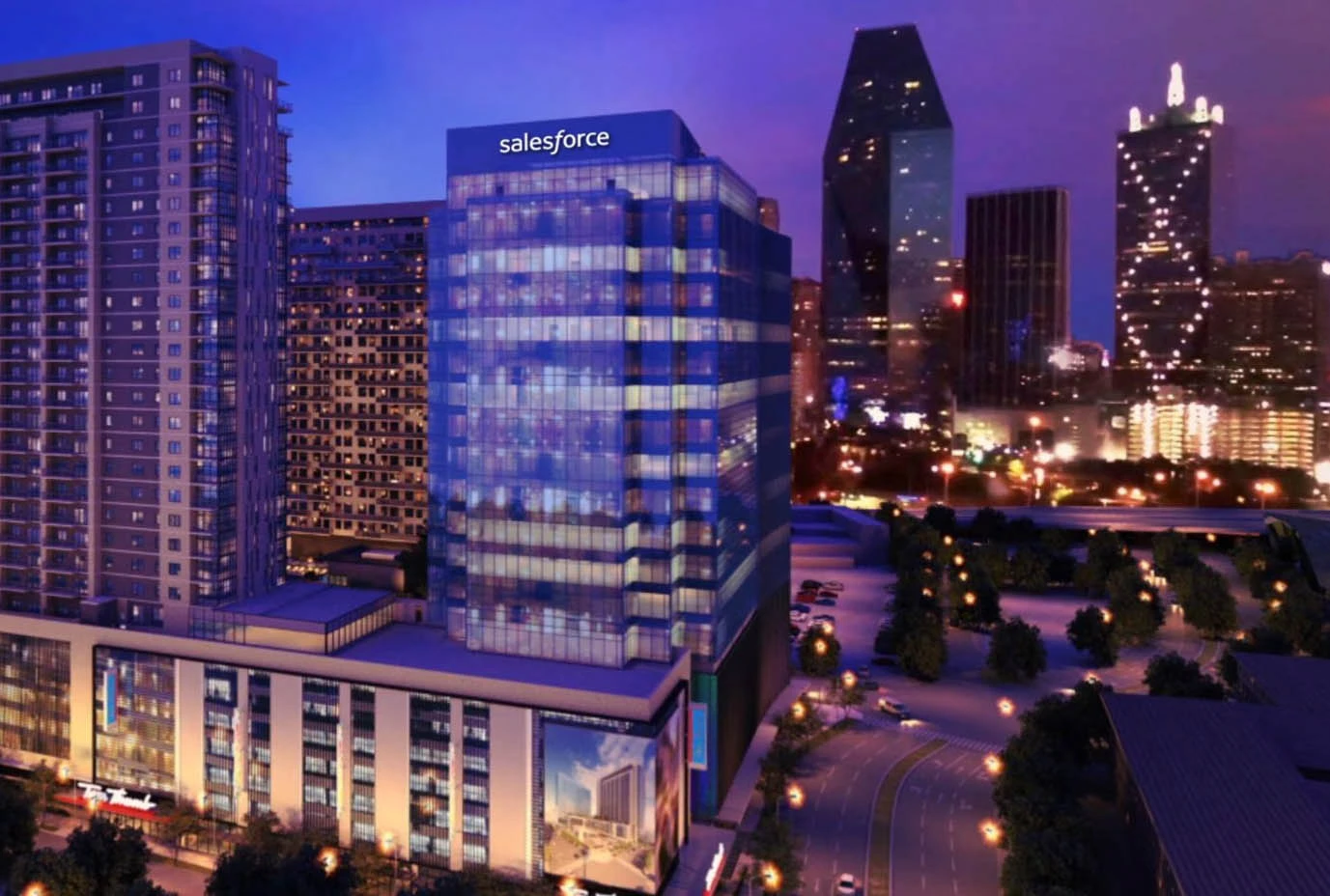 Urban high-rise tower lit at night against a city skyline